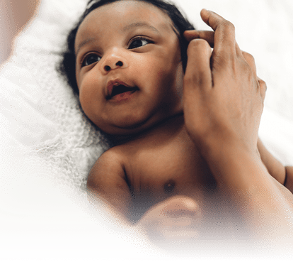 A baby looking at its parent.