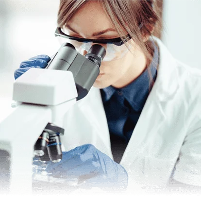 A person looking through a microscope.